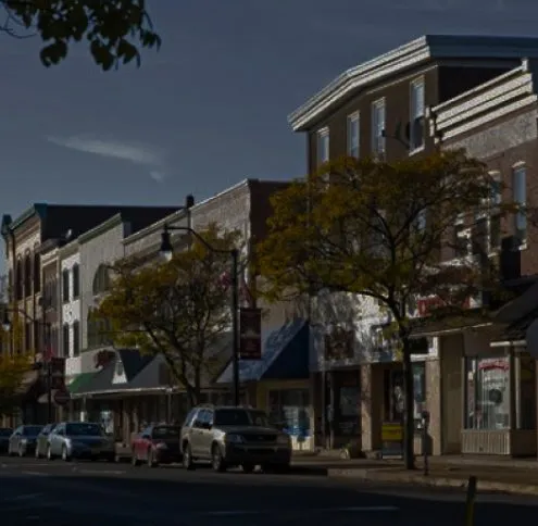 Quakertown service area: a small town main street of brick storefronts with banners hung on the lampposts