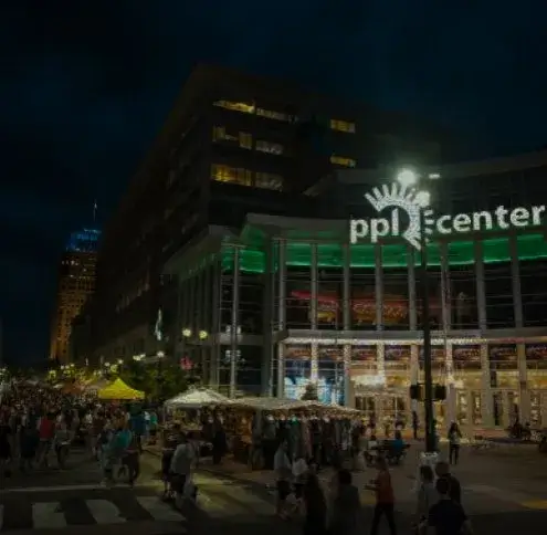 Allentown service area: a crowd filling the street at night outside the lit PPL Center arena