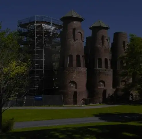 Coplay service area: a row of tall round brick cement kilns with pointed caps in a park, one wrapped in scaffolding
