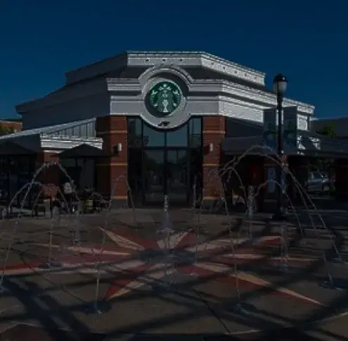 Center Valley service area: a shopping plaza corner with a coffee shop and jets of water rising from a paved fountain