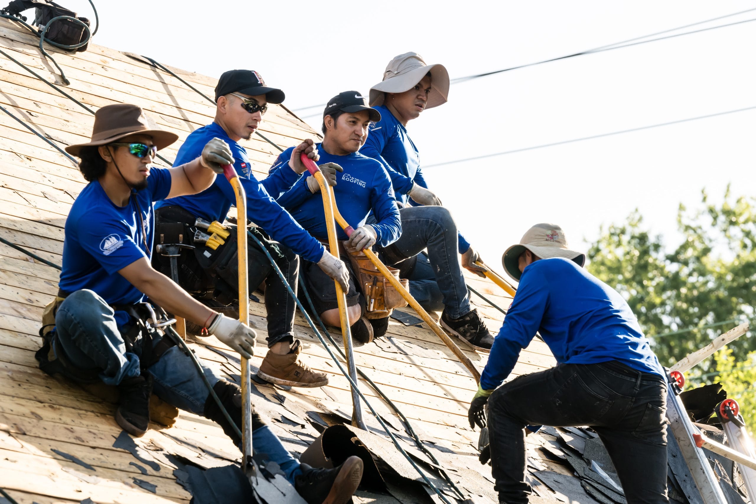 Reliable roofing contractors in Allentown consulting with each other on-site.